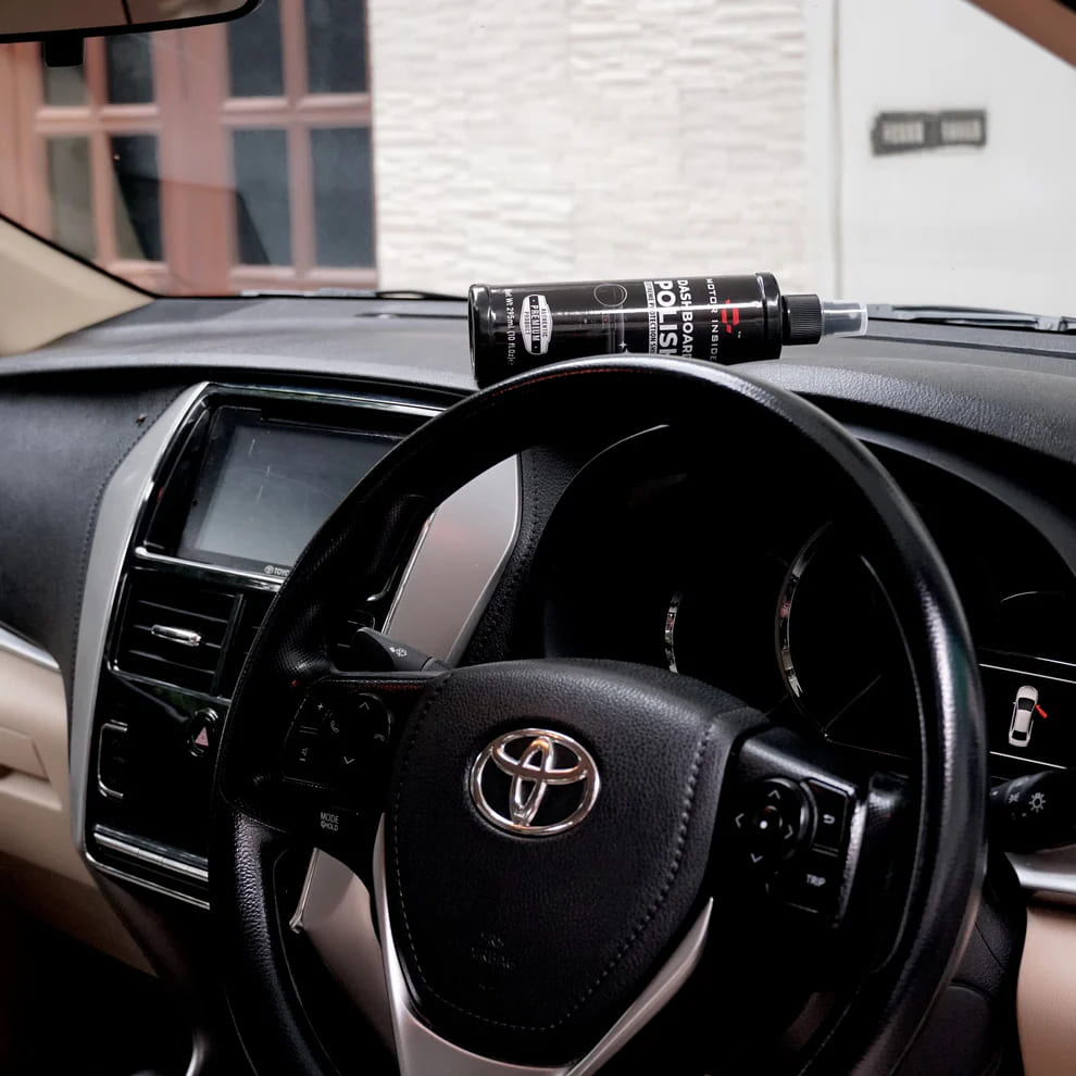 Bottle of dashboard polish on car dashboard