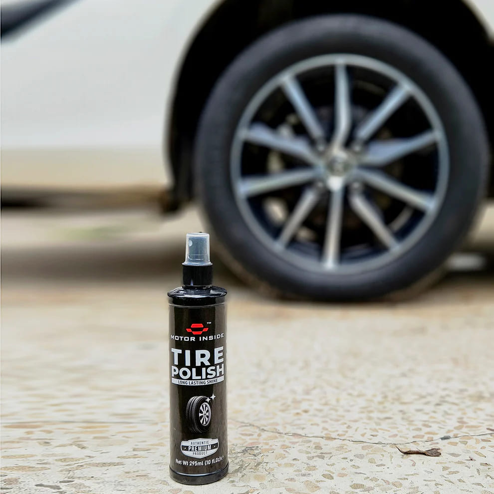 Bottle of tire polish with a car wheel in the background