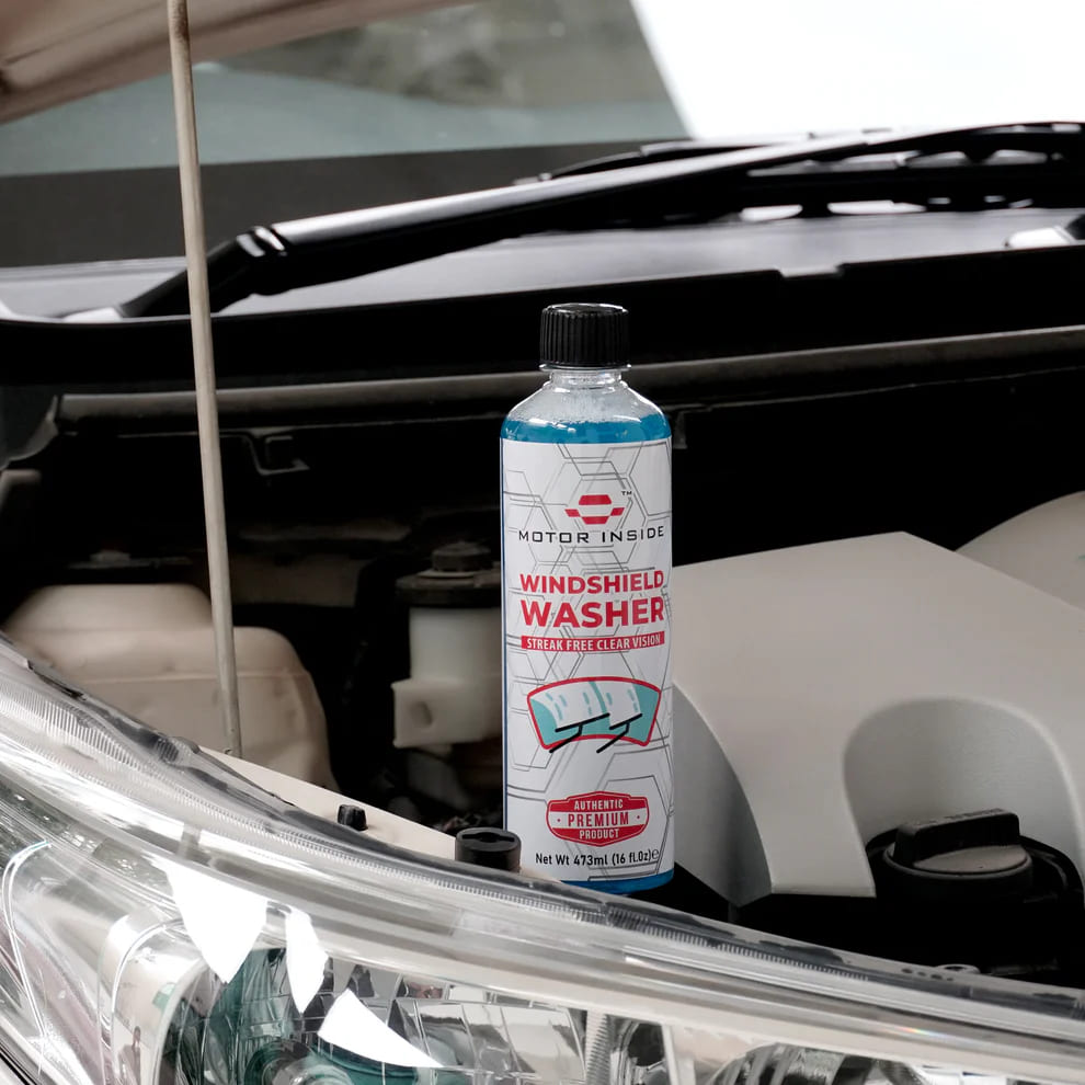 Windshield Washer bottle positioned in car engine compartment near the washer fluid reservoir